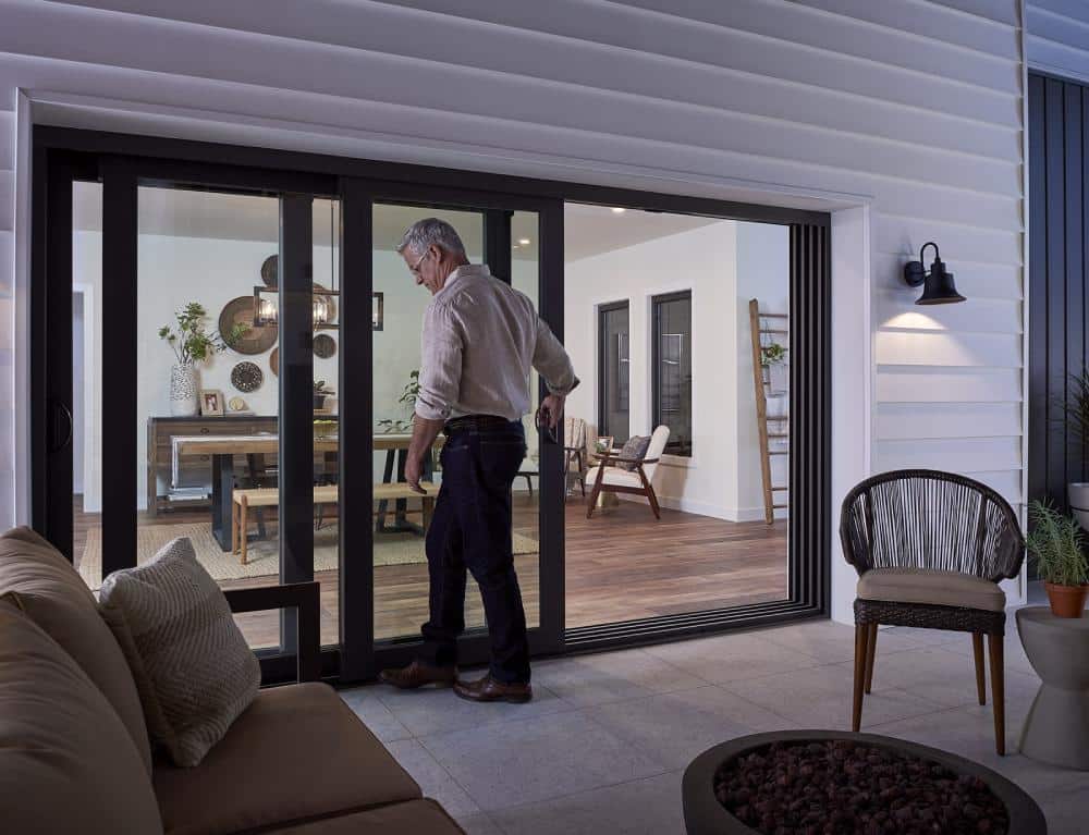 Man entering house through sliding patio door